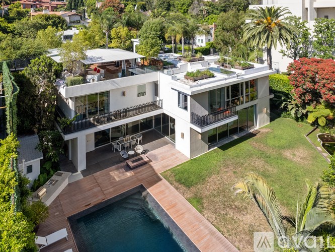 A modern house with a pool in the backyard.