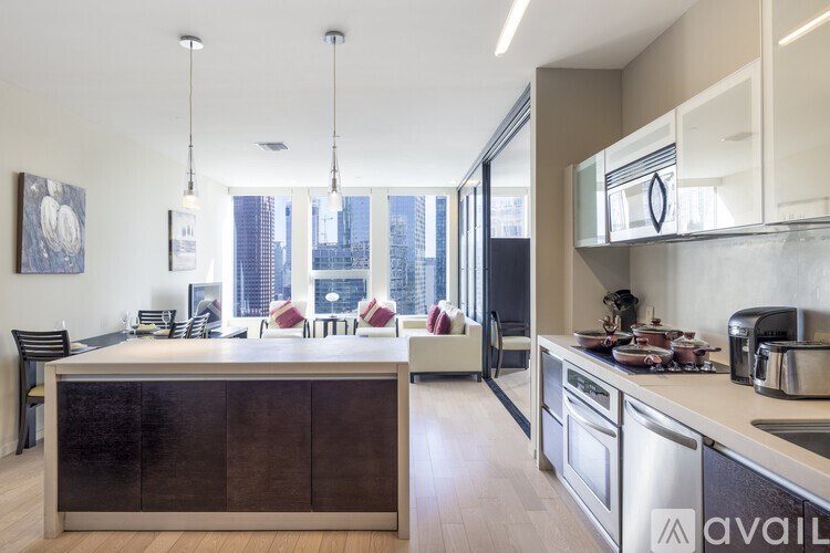 A modern kitchen with a large island and stainless steel appliances.
