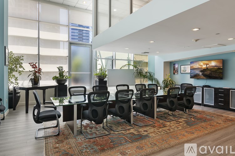 A conference room with a long table and chairs.