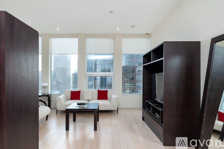A living room with a white couch and a coffee table.