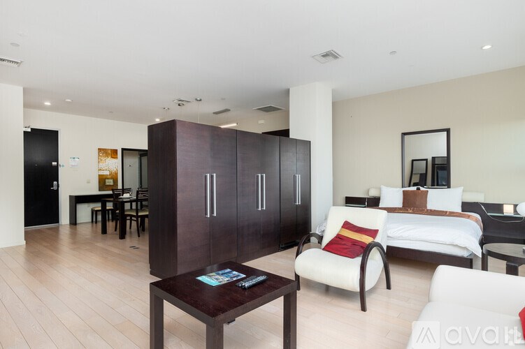 A modern living room with a white sofa and a coffee table.