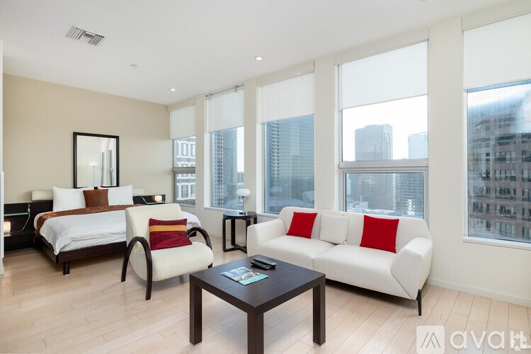 A bedroom with a large bed, a couch, and a coffee table.