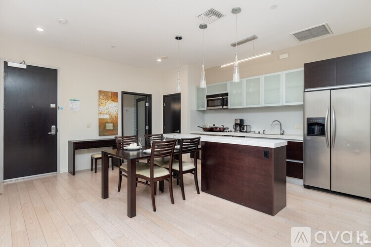 A kitchen with a table and chairs in the middle of the room.