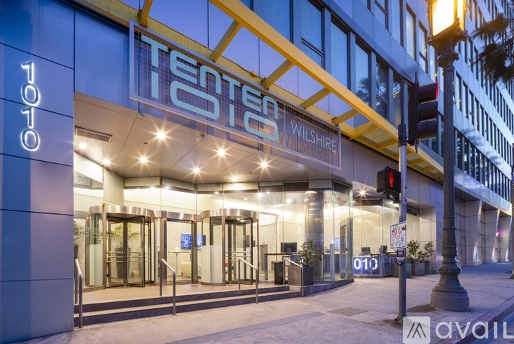 The Tento store is located in a building with a blue and yellow facade.