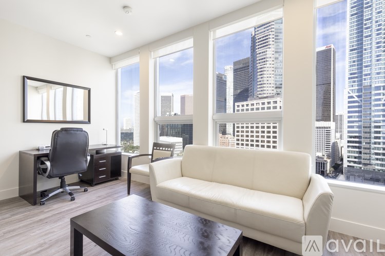 A modern living room with a view of the city skyline.