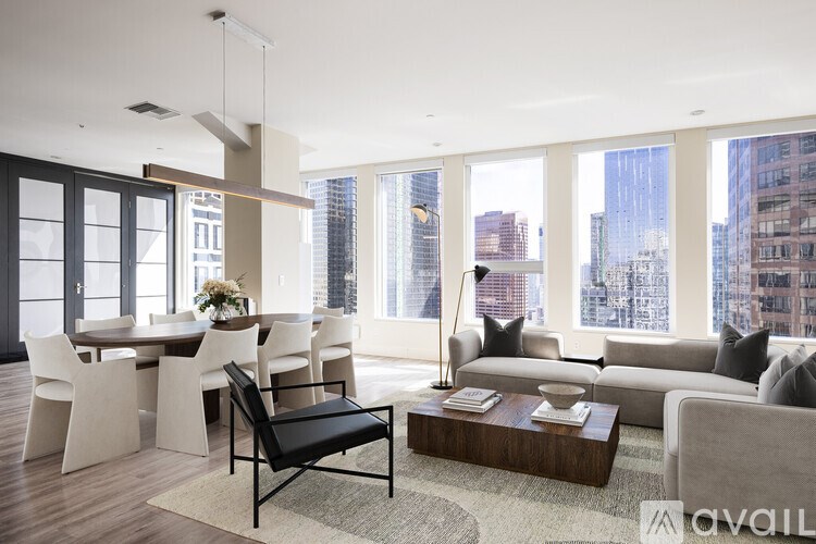 A living room with a black chair in the middle of the room.