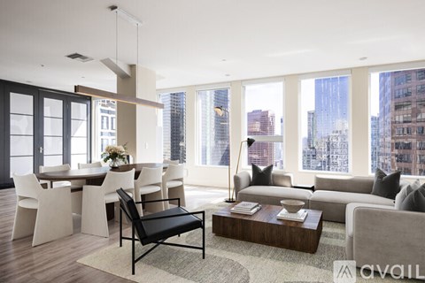 A living room with a black chair in the middle of the room.