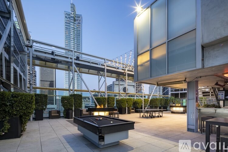 A pool table is in the middle of a patio area.