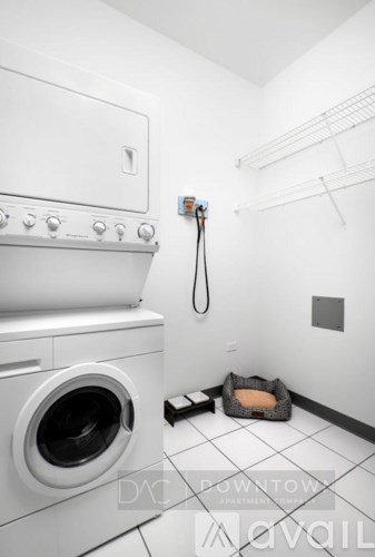 A white washing machine and dryer in a small laundry room.