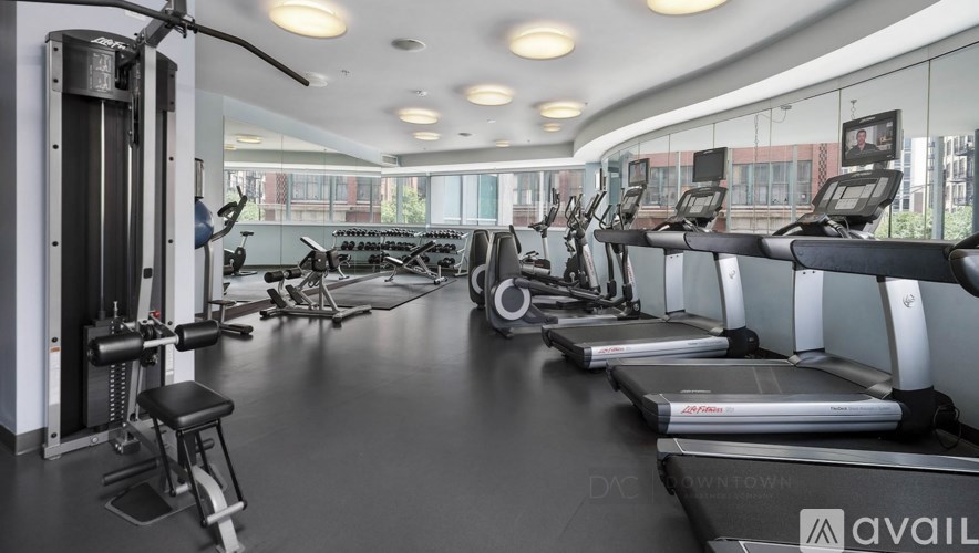 A gym with treadmills, weights, and exercise machines.