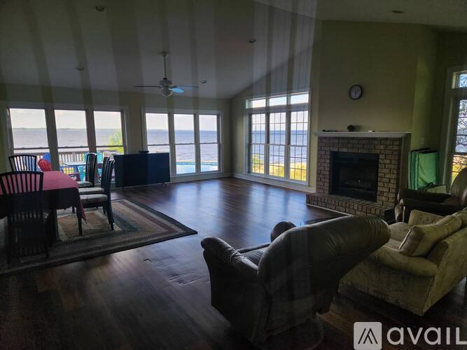 A living room with a fireplace and a television.
