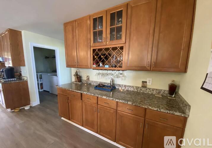 A kitchen with wooden cabinets and granite countertops.