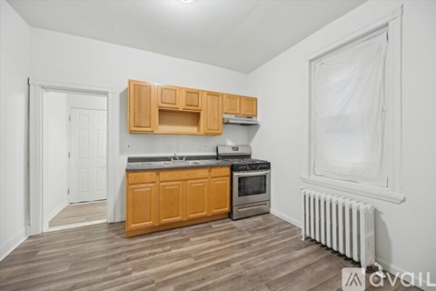 A kitchen with wooden cabinets and a white door.