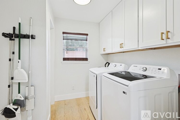 A small laundry room with a washer and dryer.