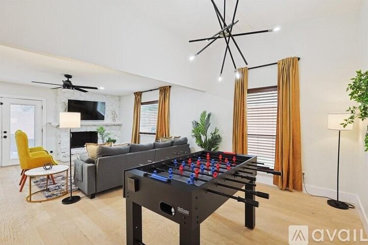 A foosball table is in the middle of a living room.