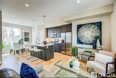 A modern kitchen with a dining table and chairs.