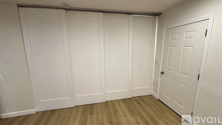 A room with white doors and a white door on the right.