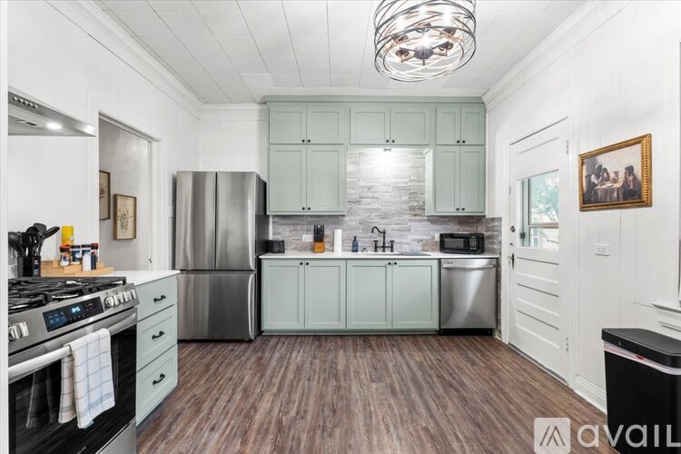 A kitchen with a stove top oven and a refrigerator.