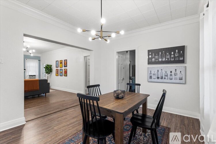 A dining room with a wooden table and chairs.