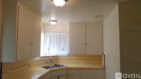 A kitchen with a sink and cabinets.