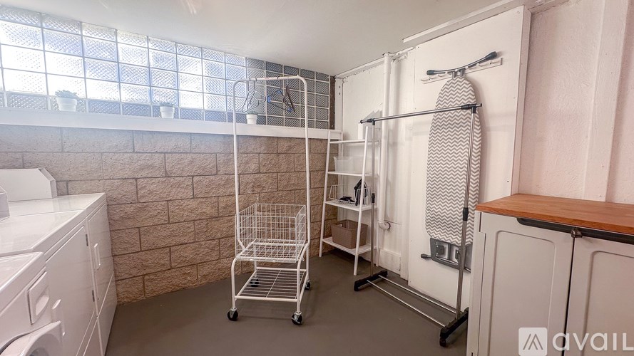 A small bathroom with a white tiled wall and a shower with a white curtain.