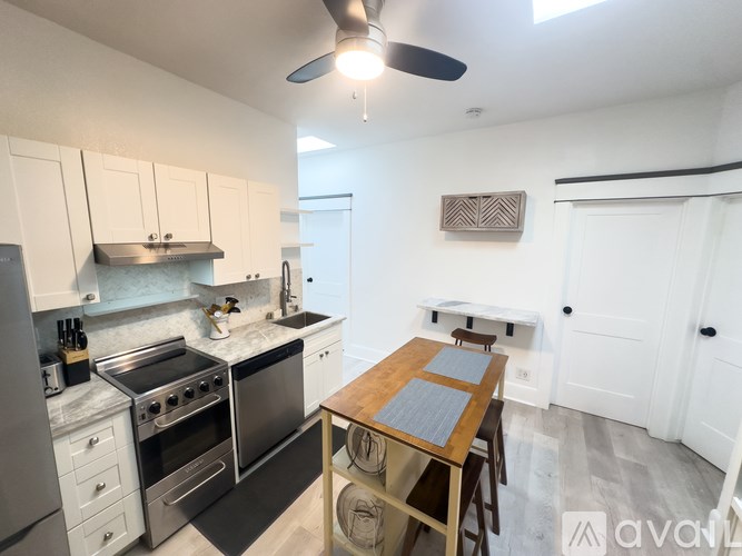A kitchen with a table and chairs in the middle of the room.