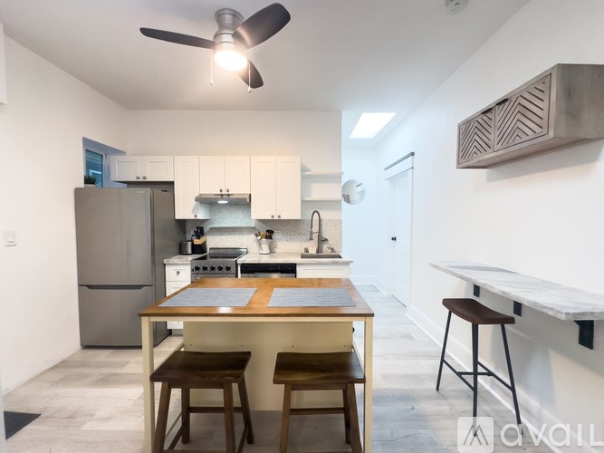 A modern kitchen with a table and chairs.