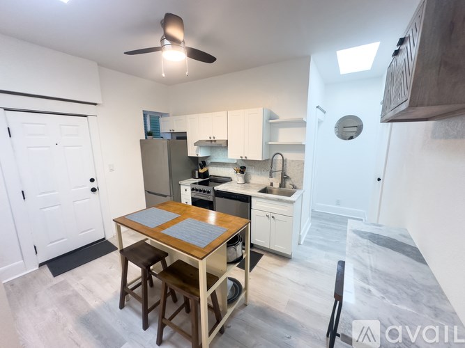 A kitchen with a table and chairs in the middle of the room.