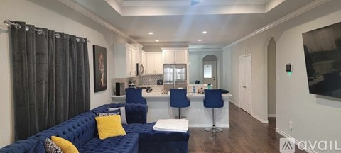 A living room with a blue couch and a television.