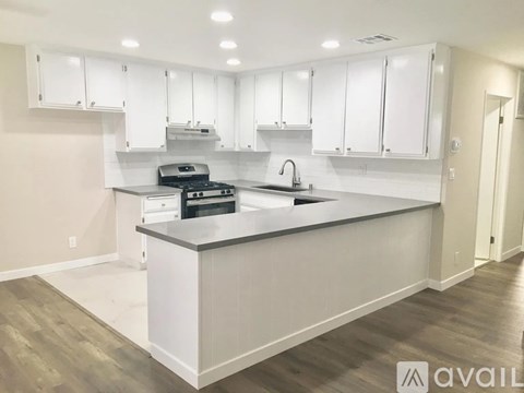 A modern kitchen with white cabinets and a large island.
