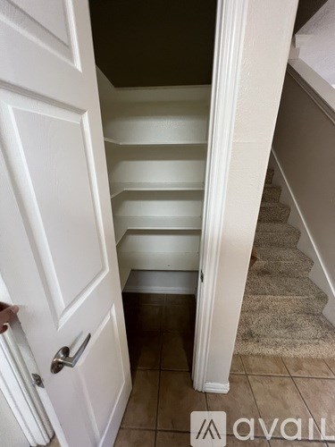 A white door is open to a staircase.