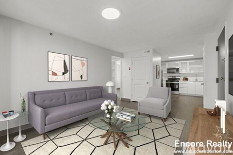 A living room with a grey couch, a glass coffee table, and a painting on the wall.