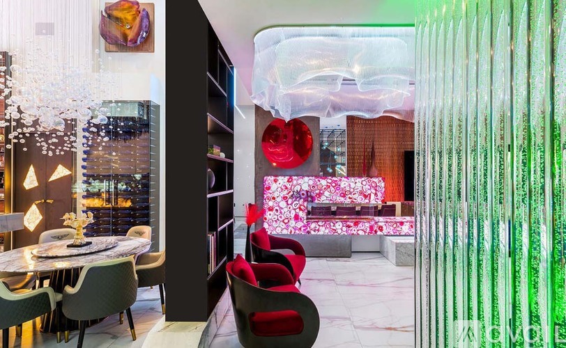 A modern dining room with a glass table and chairs.