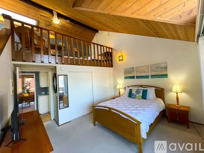 A bedroom with a bed, nightstand, and a television.