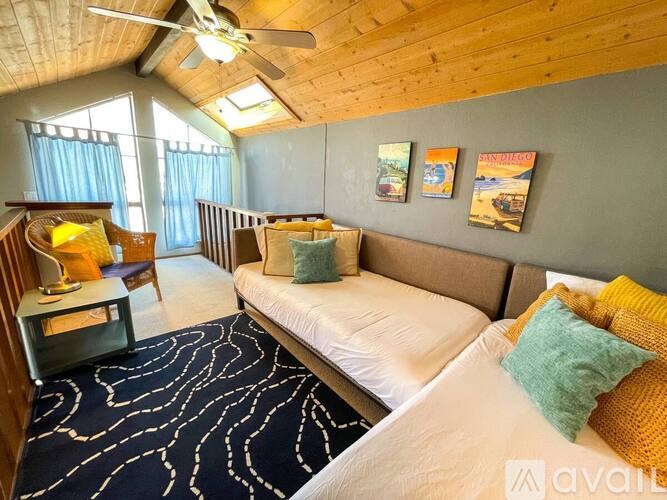 A room with two beds and a ceiling fan.