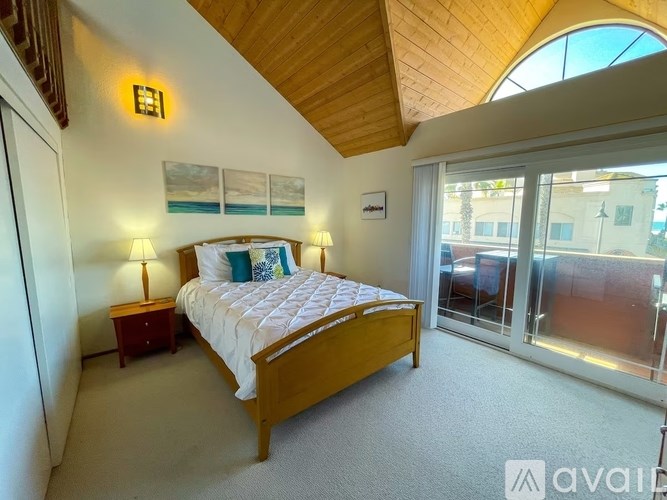 A bedroom with a large bed and a wooden headboard.