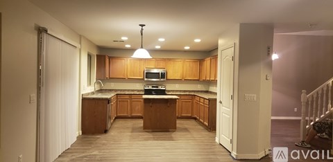 A kitchen with wooden cabinets and a white countertop.