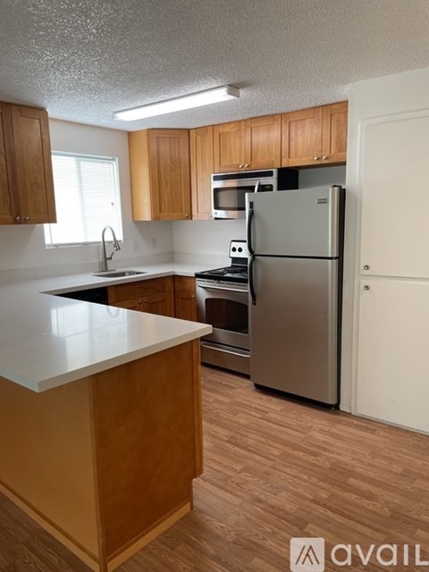A kitchen with wooden cabinets and a white countertop.