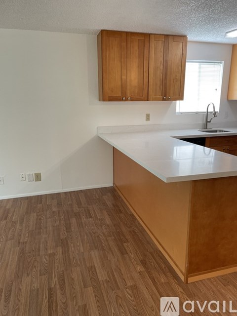 A kitchen with wooden cabinets and a white countertop.