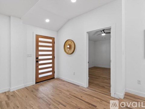 A kitchen with white cabinets and a black oven.