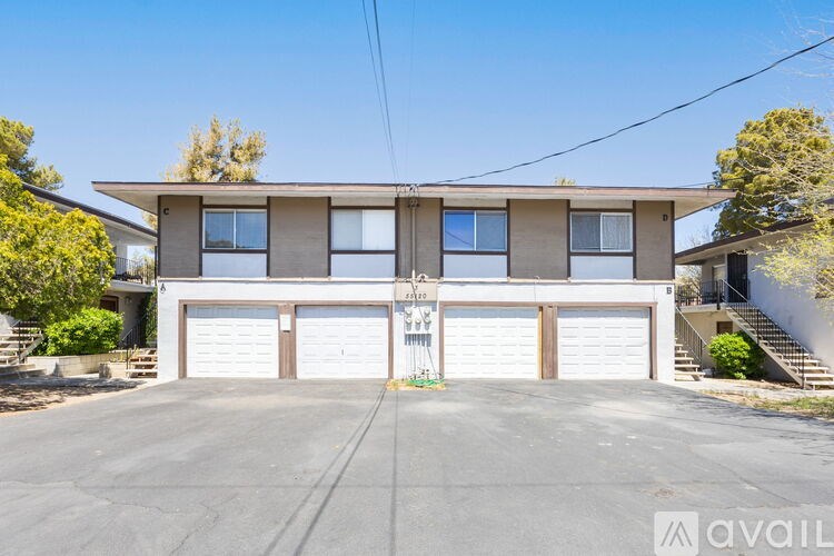 A two-story house with a garage and a driveway.