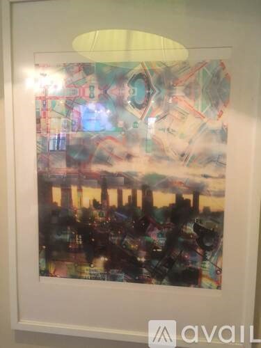 A framed picture of a cityscape with a skyline at dusk.