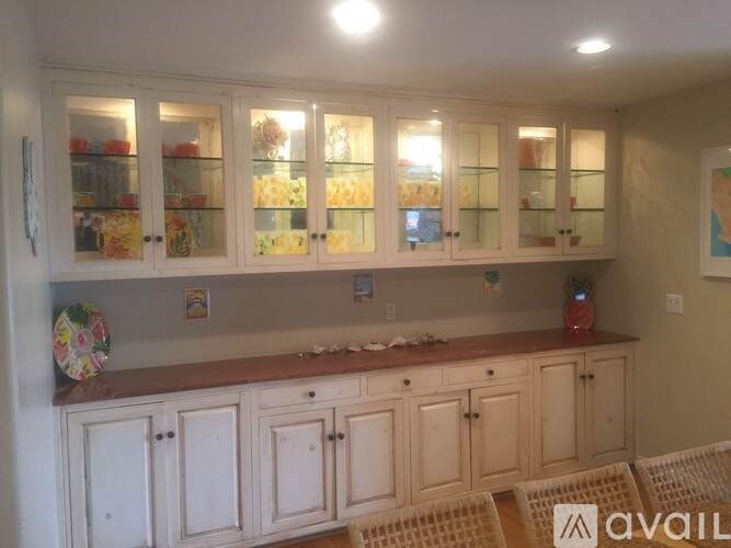 A kitchen with white cabinets and a countertop.