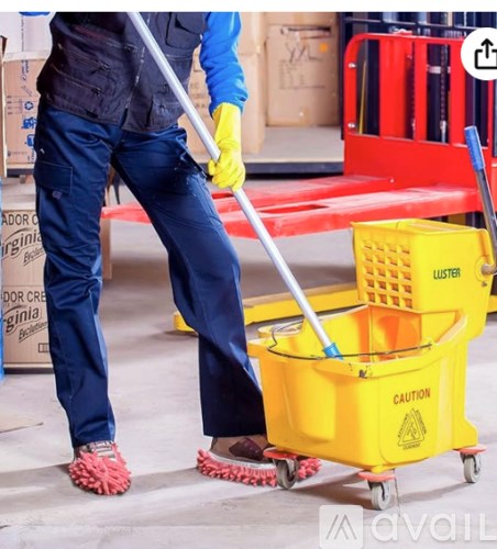 A person in a blue jacket and yellow gloves is sweeping the floor with a yellow mop.