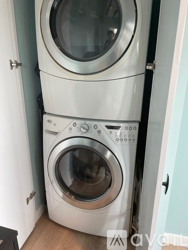 Two front loading washing machines in a small room.