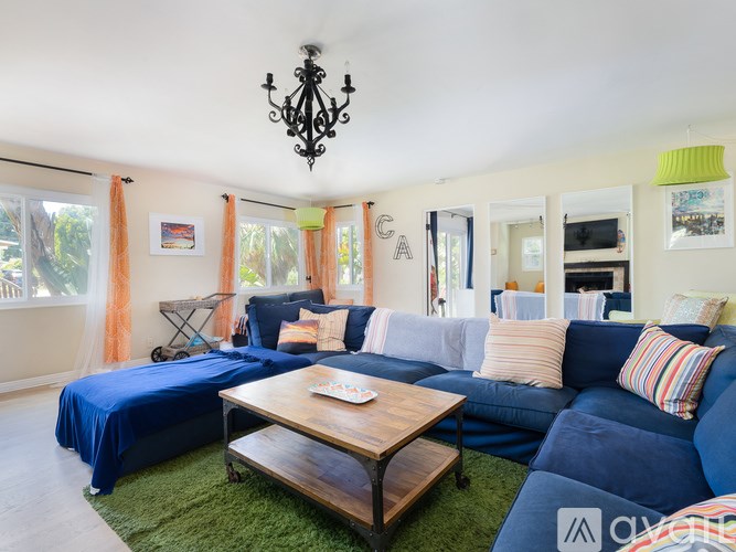 A living room with a blue couch and a wooden coffee table.