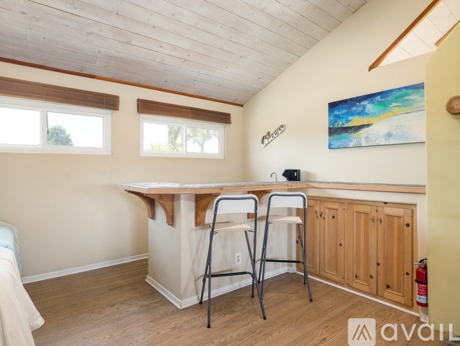 A room with a desk and chairs in it.