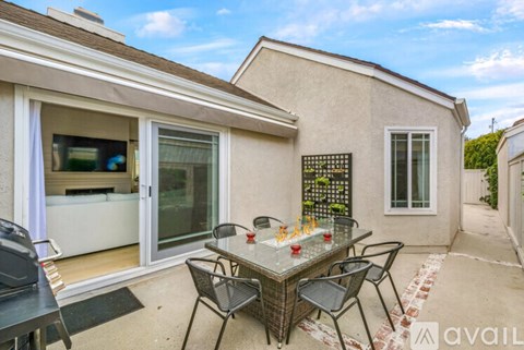 A patio with a table set for dining.