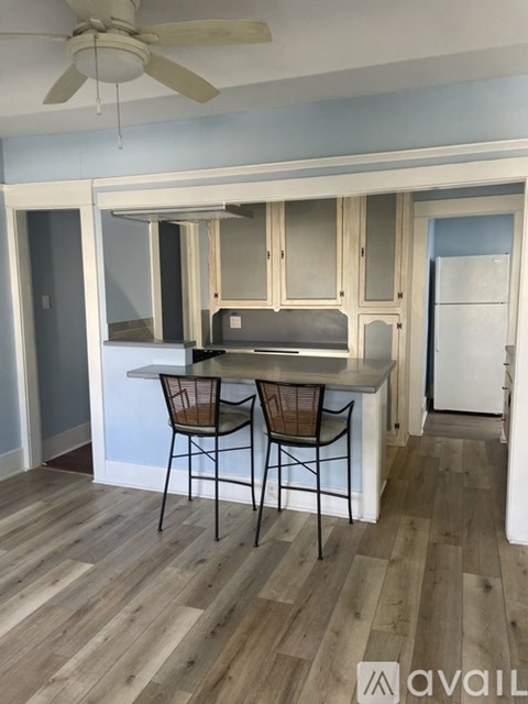 A kitchen with a table and chairs in the middle of the room.