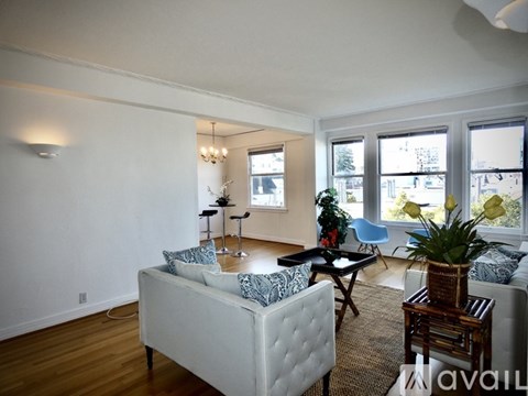 A living room with a white couch and a wooden table.